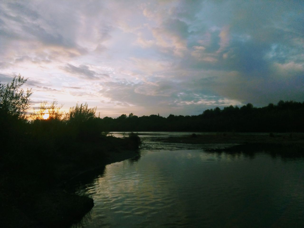 Mastering the First Impression: Your intriguing post title goes here Beautiful sunset view over a calm river in Zarinsk, Russia, reflecting the tranquil nature and peaceful surroundings.